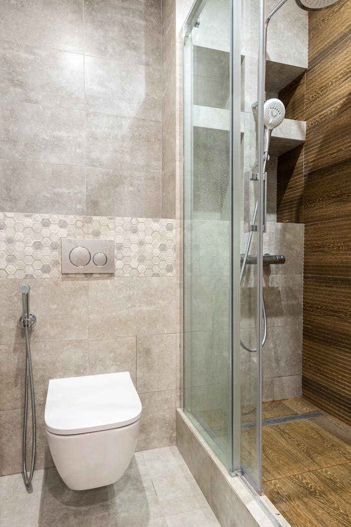 Mastering the First Impression: Your intriguing post title goes here A sleek, modern bathroom featuring a shower stall and wall-mounted toilet.