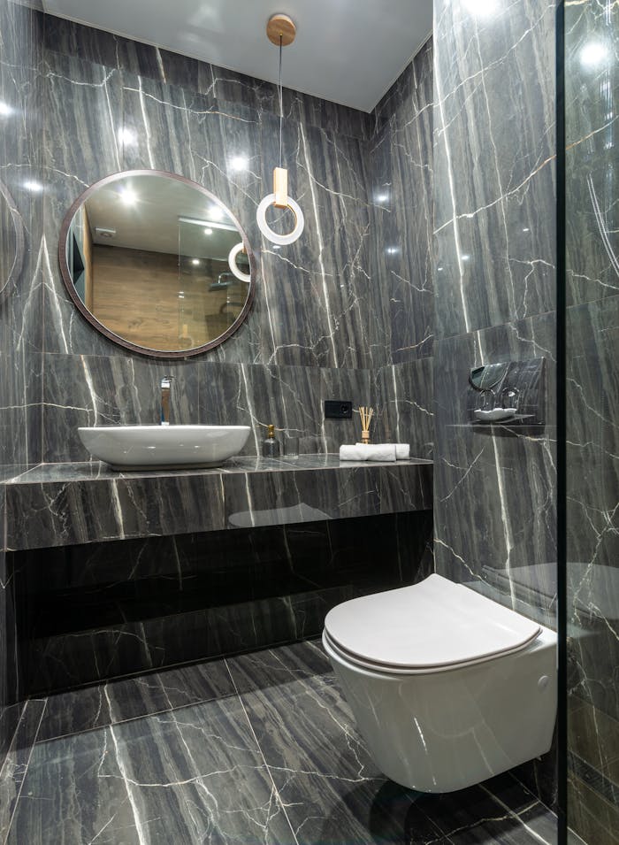 Crafting Captivating Headlines: Your awesome post title goes here Luxurious bathroom interior featuring sleek marble walls, floating sink, and a contemporary toilet design.